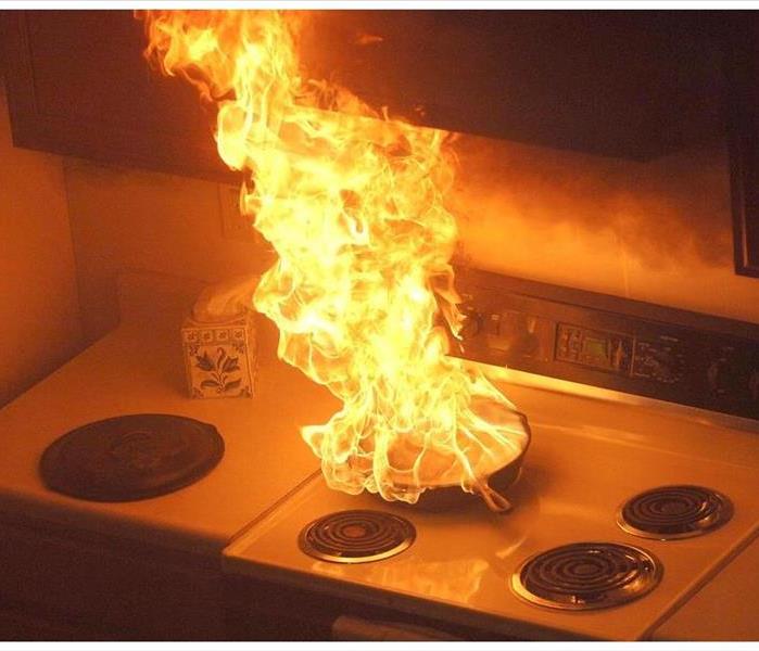 Fire erupting in kitchen pan