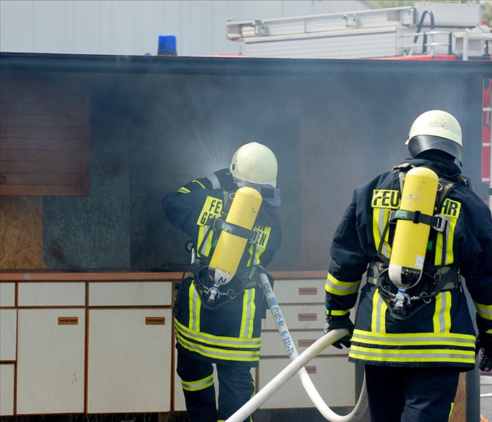 Firefighters in a smoking kitchen